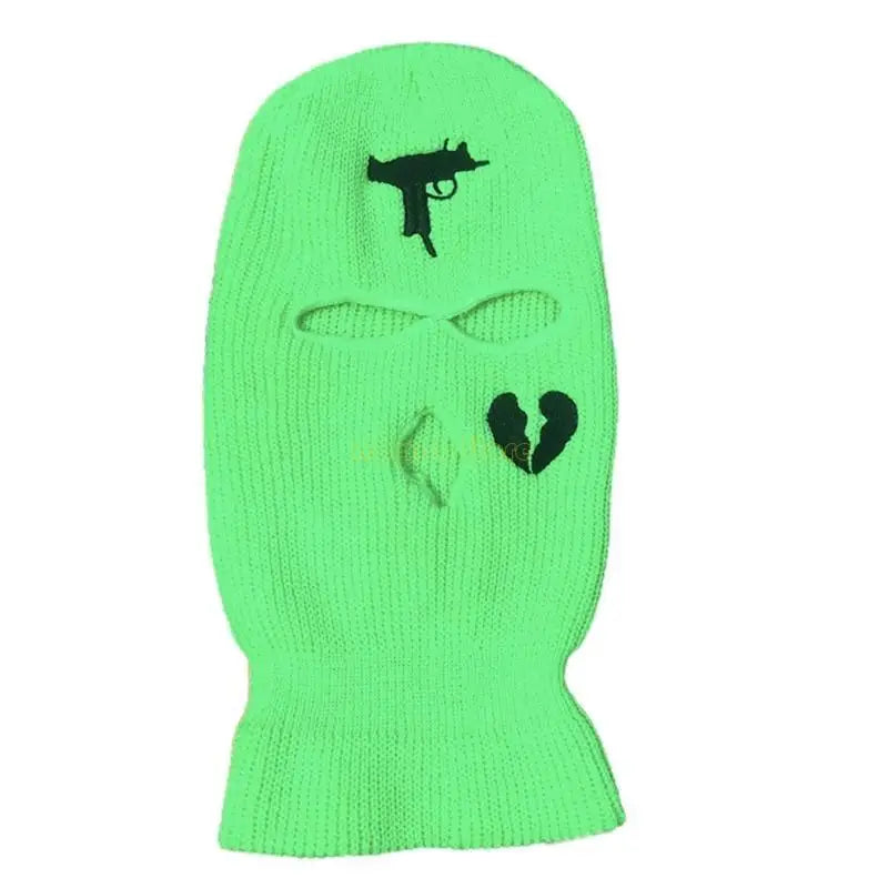 Green ski mask with black gun and heart designs on a white background