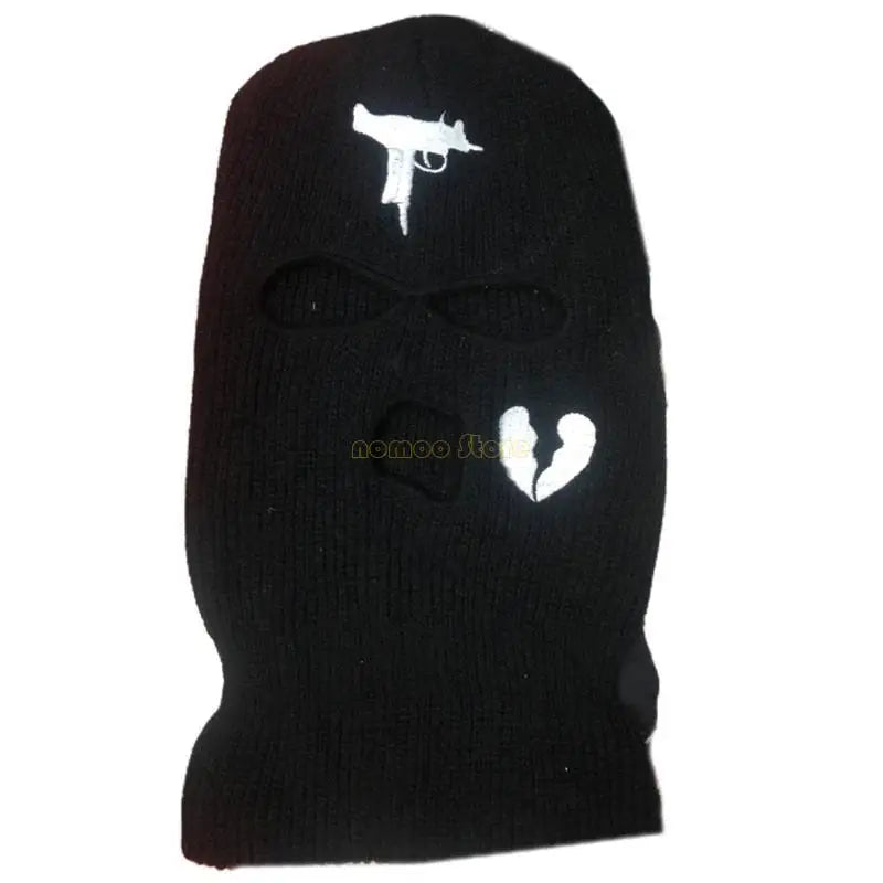 Black ski mask with white gun and heart designs on a white background
